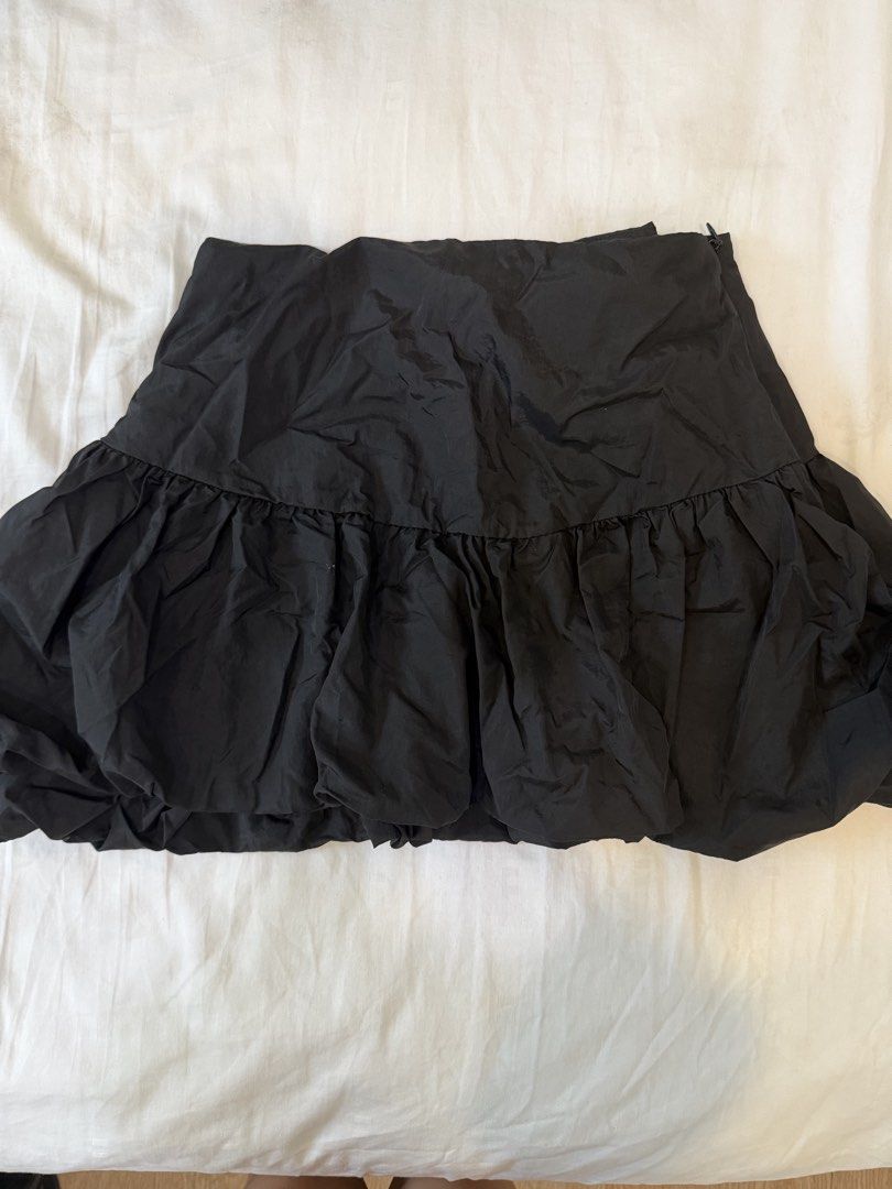 Black Ruffle Bubble Skirt (Category: Skirts) located in Mandaluyong City. Submitted by closet.me (Listing ID 1459784059, Image 1). Description: - Black bubble skirt - Ruffled hem for a fun, flirty look - Comfortable elasticated waistband - Versatile: dress up or down easily - Pairs well with various tops.