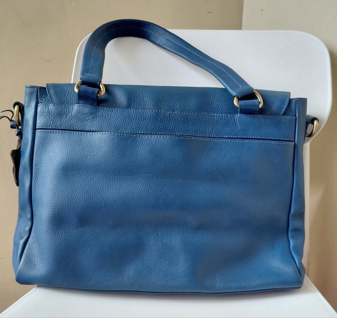Blue Genuine Leather Handbag with Shoulder Strap (Category: Shoulder Bags) located in Quezon City. Submitted by fiestypam (Listing ID 1459763936, Image 2). Description: - Genuine blue leather handbag - Flap closure - Top handle for over shoulder or handheld - Detachable shoulder strap included for crossbody - Features a '100% Genuine Leather' tag - Beautiful leather texture - Ideal for everyday use -bought for P7800+ -no cracks, no dirt, still sm