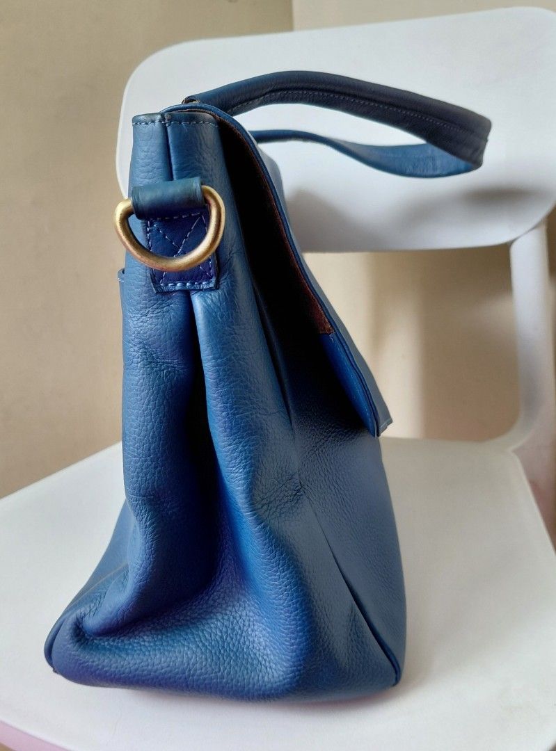 Blue Genuine Leather Handbag with Shoulder Strap (Category: Shoulder Bags) located in Quezon City. Submitted by fiestypam (Listing ID 1459763936, Image 3). Description: - Genuine blue leather handbag - Flap closure - Top handle for over shoulder or handheld - Detachable shoulder strap included for crossbody - Features a '100% Genuine Leather' tag - Beautiful leather texture - Ideal for everyday use -bought for P7800+ -no cracks, no dirt, still sm