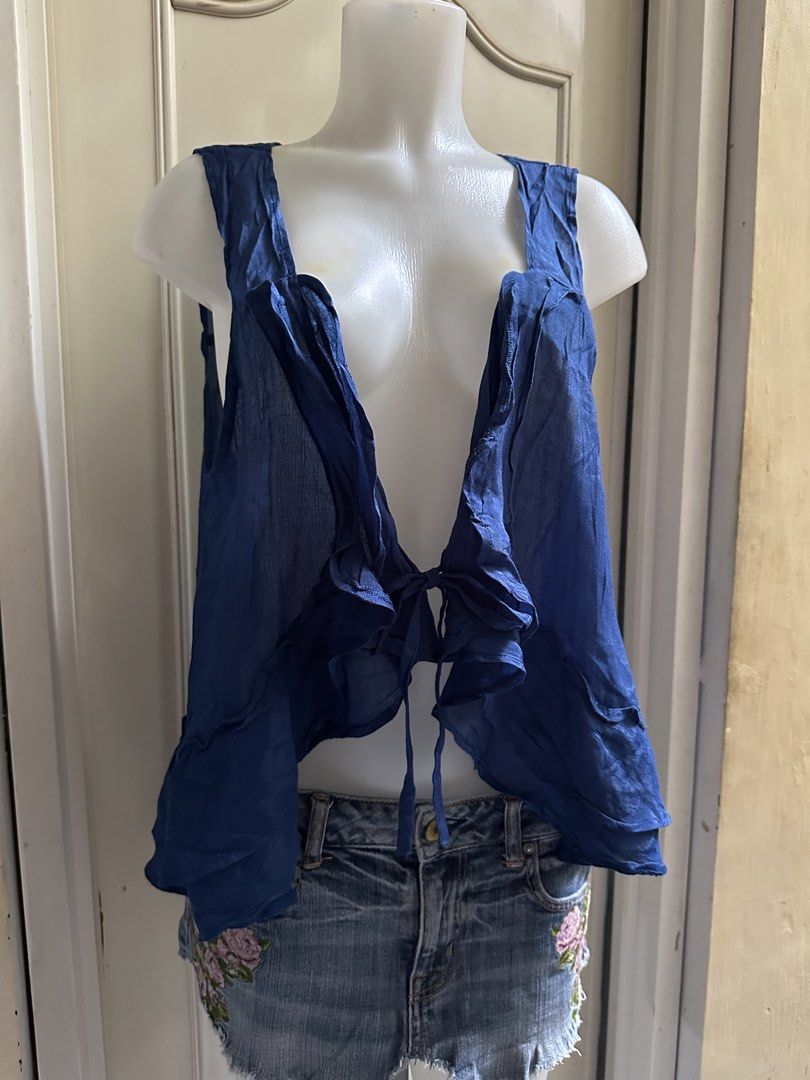 Blue sheer ruffled tie-front vest M-L (Category: Sleeveless) located in Calapan. Submitted by shakalak (Listing ID 1459753079, Image 2). Description: - Sheer blue vest - Ruffled edges and hem - Ties at the front with string - Sleeveless design - Lightweight and flowy material - Ideal for layering over tops or dresses.