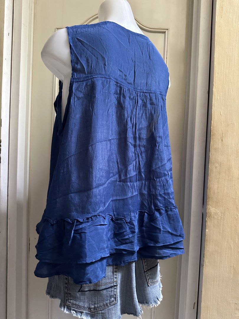 Blue sheer ruffled tie-front vest M-L (Category: Sleeveless) located in Calapan. Submitted by shakalak (Listing ID 1459753079, Image 3). Description: - Sheer blue vest - Ruffled edges and hem - Ties at the front with string - Sleeveless design - Lightweight and flowy material - Ideal for layering over tops or dresses.