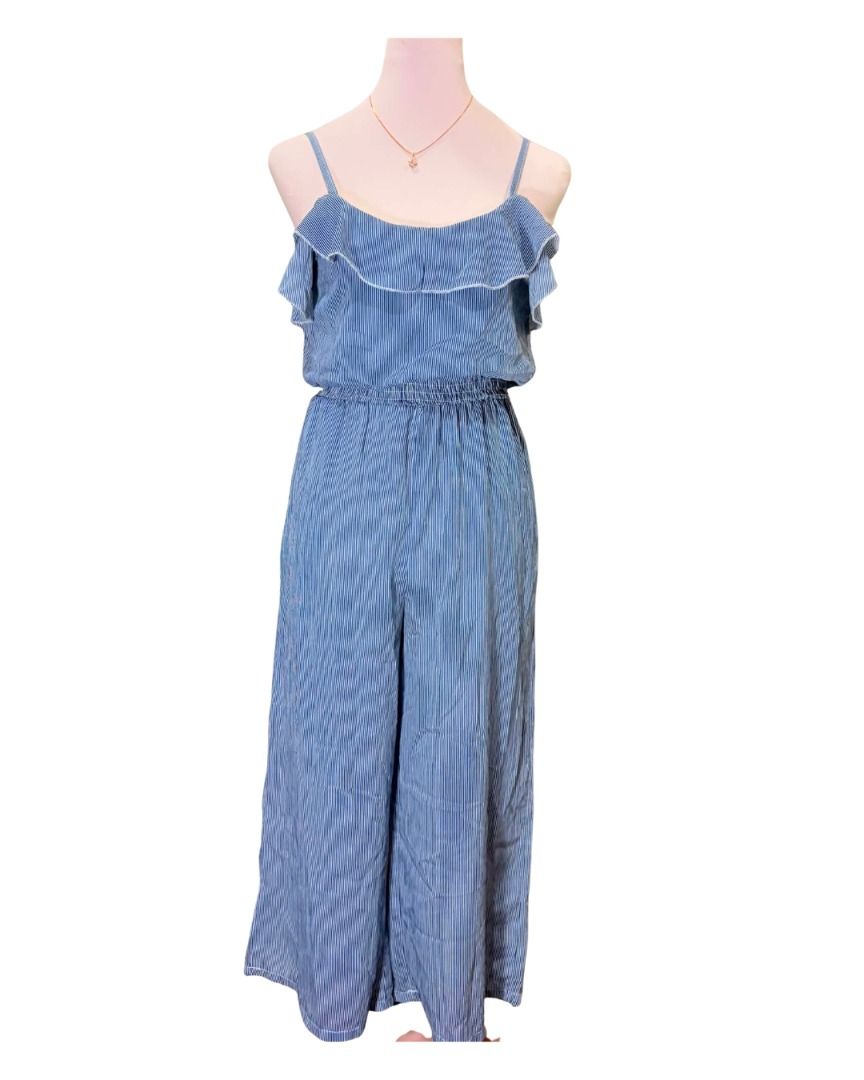 Blue Striped Ruffle Cold Shoulder Jumpsuit (Category: Jumpsuits) located in Baguio. Submitted by ellamell (Listing ID 1459744465, Image 1). Description: 43cm bust 30cm waist 102cm length/height - Stretchable waist - Adorable blue striped jumpsuit - Has pockets - Trendy cold-shoulder design - Sweet ruffle details on shoulders - Comfortable elastic waistband - Relaxed, wide, flowy legs - Ideal for casual outings or beach trips - Effortlessly stylis