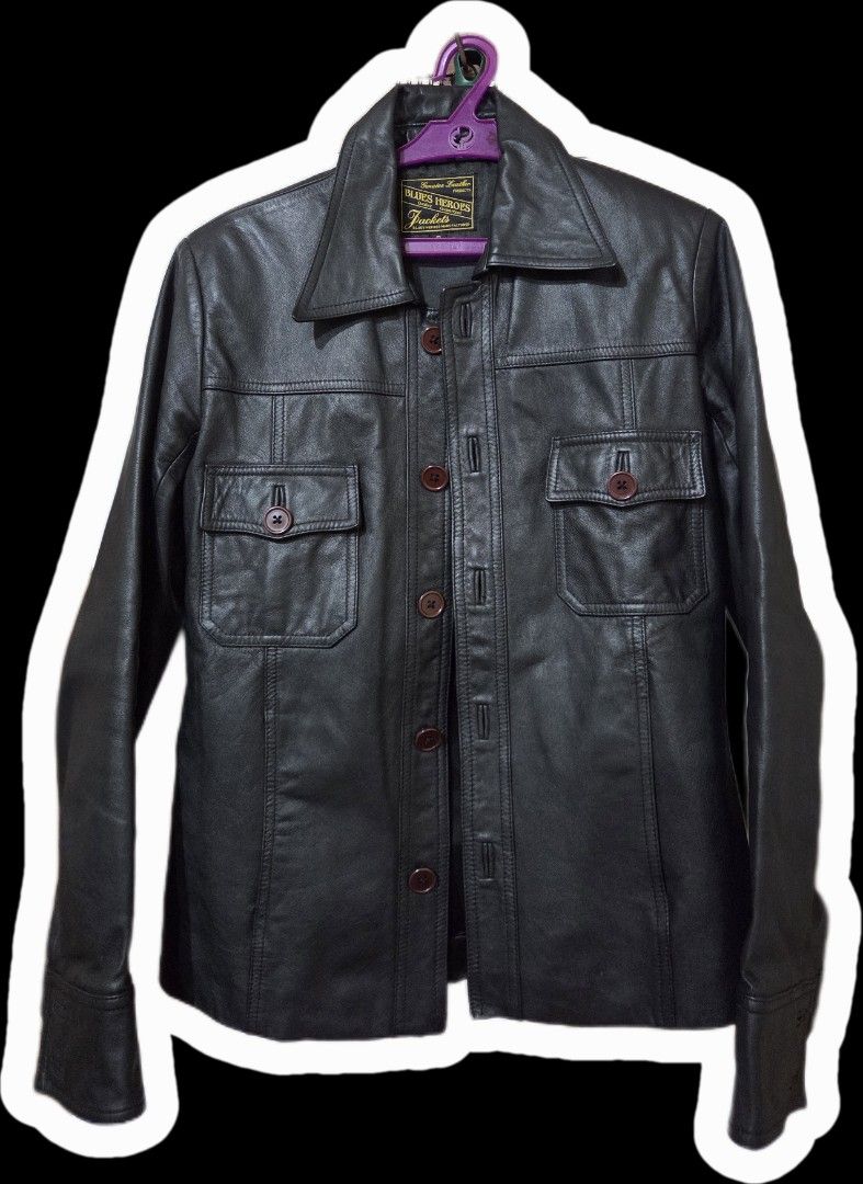 Blues Heroes Genuine Leather Jacket (Category: Coats, Jackets and Outerwear) located in Manila. Submitted by aeymin (Listing ID 1459815028, Image 1). Description: - Genuine black leather jacket by Blues Heroes - Two chest pockets with button closures - Button-up front - Classic collar - Button cuffs - Versatile for layering or wearing on its own - A timeless wardrobe essential Dimensions: LxW = 24x18 Color and condition: 9/10. No issues.