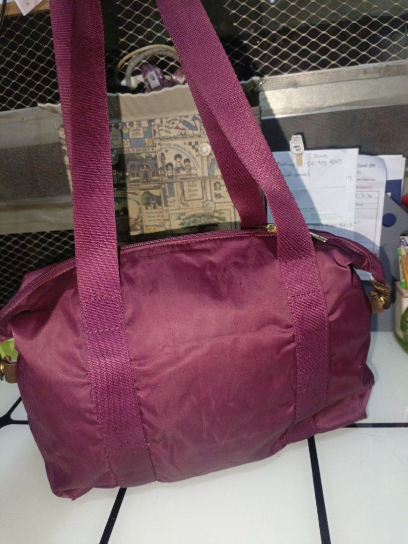 Bricks Small Duffel Bag Nylon (Category: Tote Bags) located in San Pedro. Submitted by elevens_online_thrift_shop (Listing ID 1459755723, Image 2). Description: **Item Description** * **Brand & Origin:** A Bric's brand duffel/travel bag featuring a leather logo patch and interior tag indicating authenticity from "Bric's Boutique, Galleria Vittorio Emanuele, Milano". * **Material & Design:** Made of a durable burgundy/maroon nylon fabric with matc