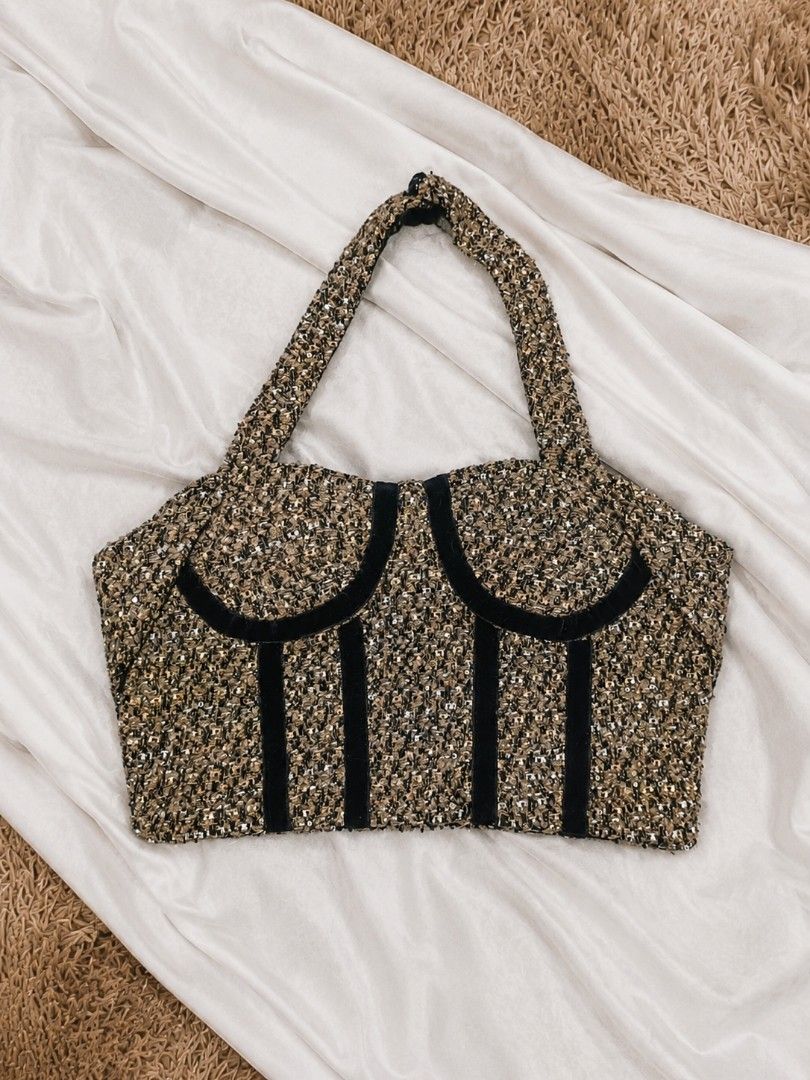Brown Halter Tweed Corset Style Top (Category: Sleeveless) located in Manila. Submitted by dear.naiah (Listing ID 1459791276, Image 1). Description: •Chic brown & gold tweed fabric with subtle sparkle •Unique corset-inspired silhouette with black velvet detailing •Structured shape with a statement handle •Perfect for adding a classy, feminine touch to any outfit • Great for casual days, brunch dates, or special occasions.