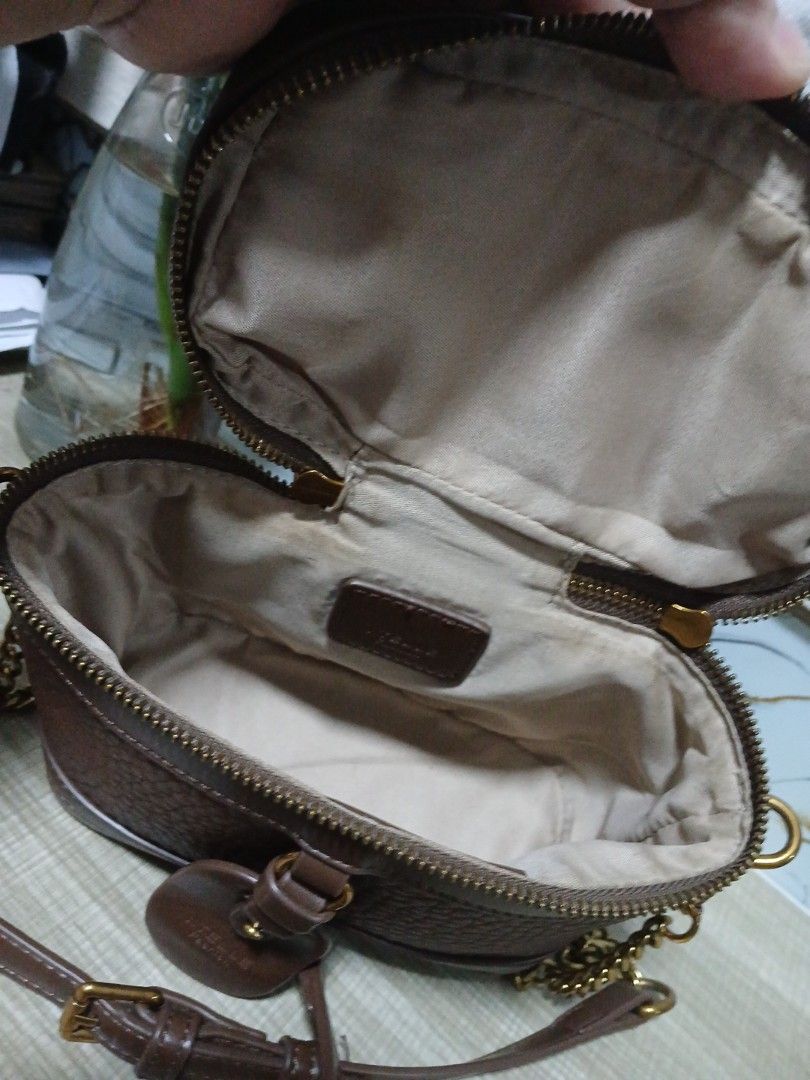 Brown Leather Vanity Bag with Gold Chain Strap (Category: Luxury Bags & Wallets) located in Taguig. Submitted by jegadablo (Listing ID 1459812865, Image 3). Description: - Stylish brown leather vanity bag - Textured finish for a premium look - Elegant gold chain strap and top handle - Secure zipper closure - Cute buckle detail on the front flap - Compact size, ideal for carrying essentials.
