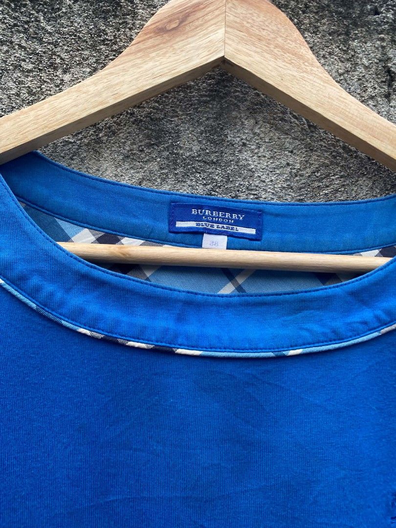 Burberry Blue Label Blue T-shirt (Category: Tshirts & Polo Shirts ) located in Bansalan. Submitted by thriftyzzz (Listing ID 1459806079, Image 3). Description: - Burberry Blue Label blue t-shirt - Short sleeves with white trim - Round neckline with white trim - Small Burberry logo detail on chest - Tagged size 38 - Ideal for everyday casual wear - Issue color rate - slightly scratched on the back neck - Very good condition.