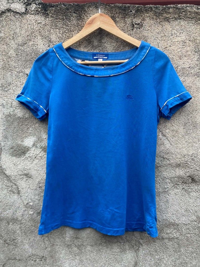 Burberry Blue Label Blue T-shirt (Category: Tshirts & Polo Shirts ) located in Bansalan. Submitted by thriftyzzz (Listing ID 1459806079, Image 1). Description: - Burberry Blue Label blue t-shirt - Short sleeves with white trim - Round neckline with white trim - Small Burberry logo detail on chest - Tagged size 38 - Ideal for everyday casual wear - Issue color rate - slightly scratched on the back neck - Very good condition.