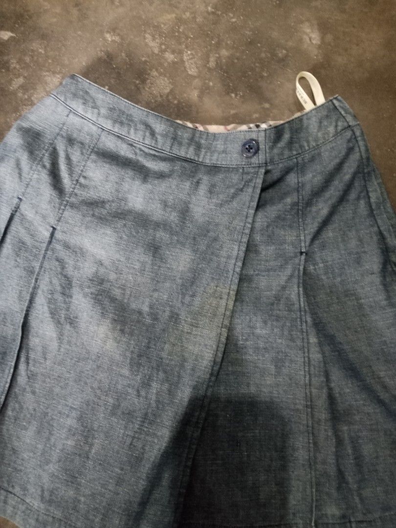 Burberry Denim Skort Shorts (Category: Shorts) located in Manila. Submitted by romeoamoro00044 (Listing ID 1459723038, Image 2). Description: - Burberry denim skort - Wrap front with button closure - Elasticated back waistband for comfort - Burberry logo detail on back pocket - Lined with signature Burberry plaid - Ideal for casual wear.