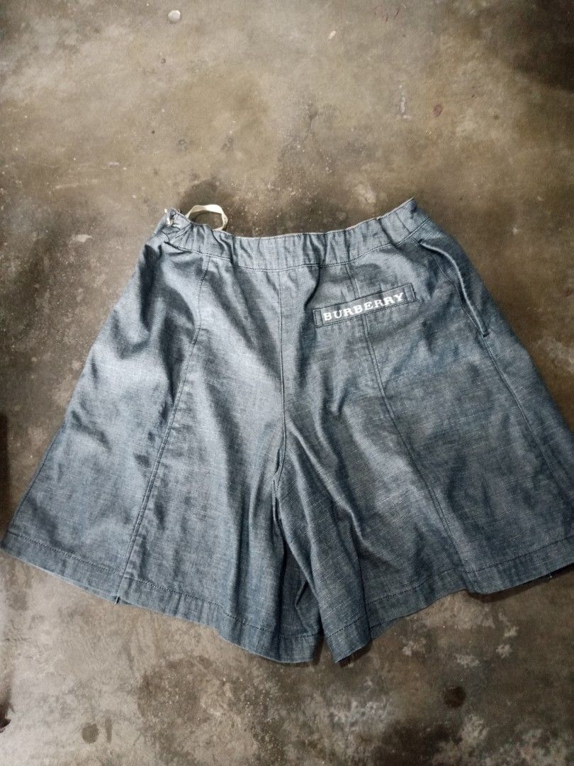 Burberry Denim Skort Shorts (Category: Shorts) located in Manila. Submitted by romeoamoro00044 (Listing ID 1459723038, Image 3). Description: - Burberry denim skort - Wrap front with button closure - Elasticated back waistband for comfort - Burberry logo detail on back pocket - Lined with signature Burberry plaid - Ideal for casual wear.