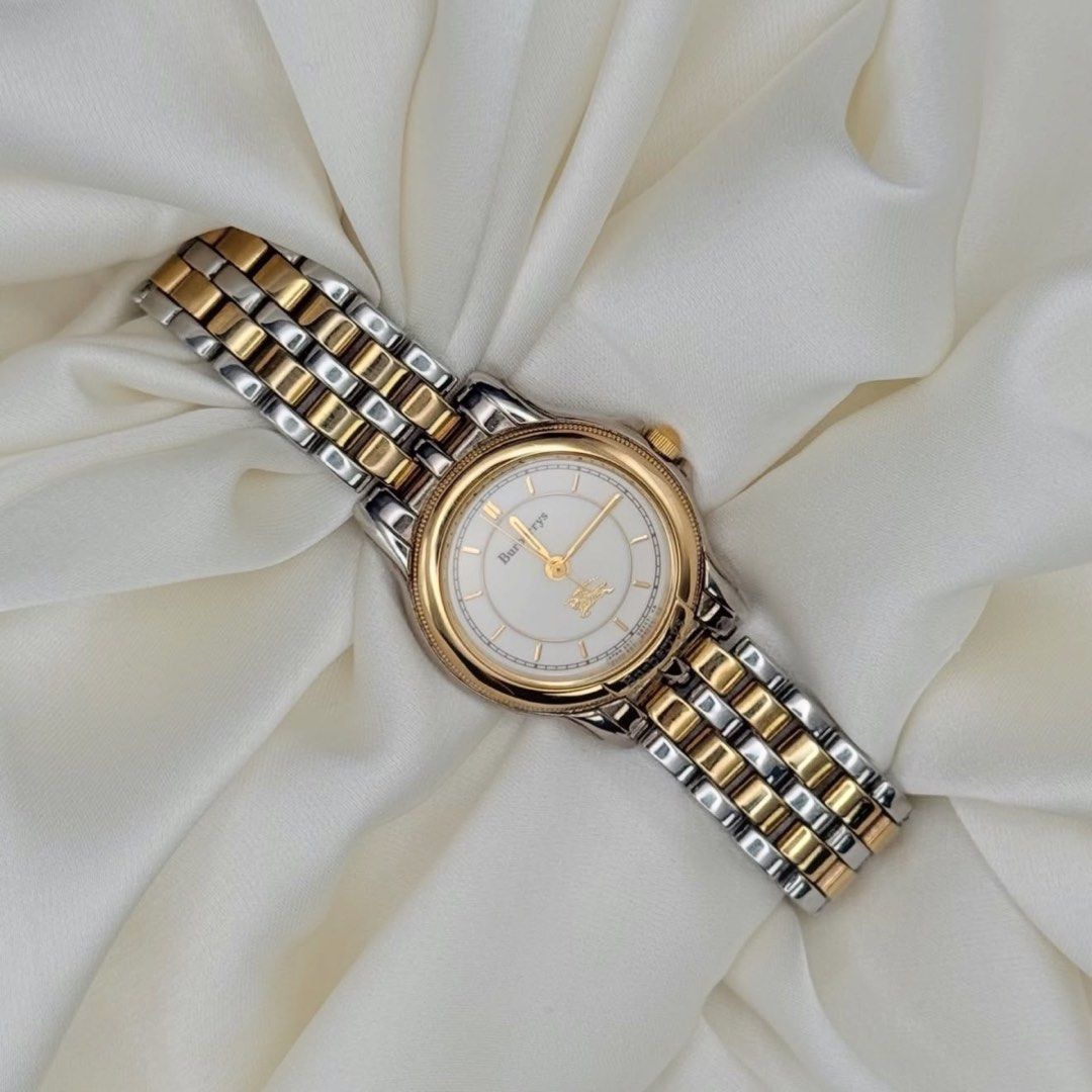 Burberry Two-Tone Watch (Category: Luxury Watches) located in Lipa City. Submitted by watchoutph (Listing ID 1459825877, Image 1). Description: Burberrys Two-toned Watch Gold bezel Cream dial Gold hands and indices 16.5cm wrist size 24mm case size ₱7,800.