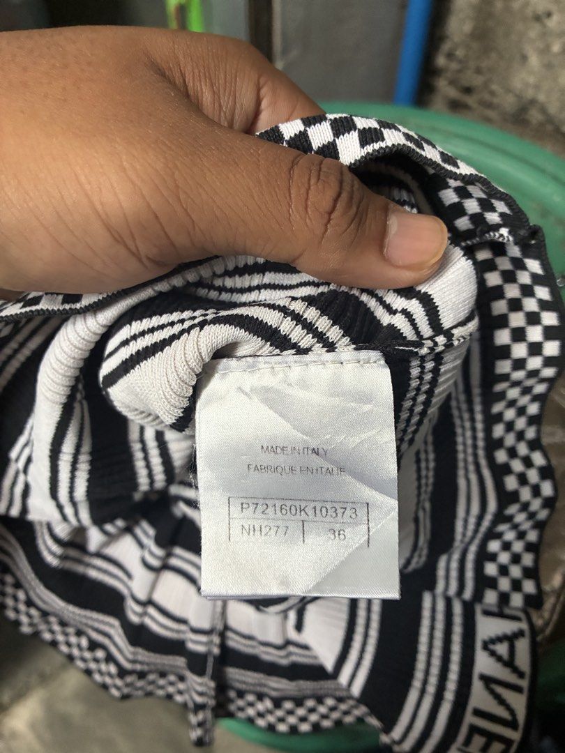 Chanel Black & White Striped Knit Top (Category: Luxury Apparel) located in Manila. Submitted by assortedgoodsv3 (Listing ID 1459720400, Image 2). Description: - Chanel knit top - Size: 36 - Color: Black and white stripes - Design: Checkerboard trim - Features: 'CHANEL' logo on collar, cuffs, and hem - Origin: Made in Italy - Condition: Great piece for any fashion lover.