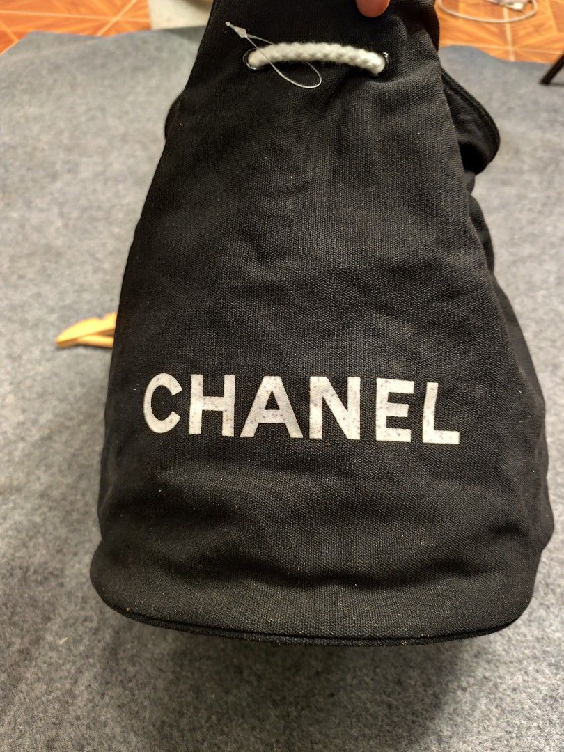 Chanel Black Drawstring Bag (Category: Luxury Bags & Wallets) located in Cordova. Submitted by bsb.streetluxvintage.clothing (Listing ID 1459783779, Image 3). Description: - Authentic Chanel drawstring bag - Iconic Chanel logo on the front - Interior lining with repeating Chanel logo pattern - White rope handles for drawstring closure - Ideal for everyday use or travel accessory.
