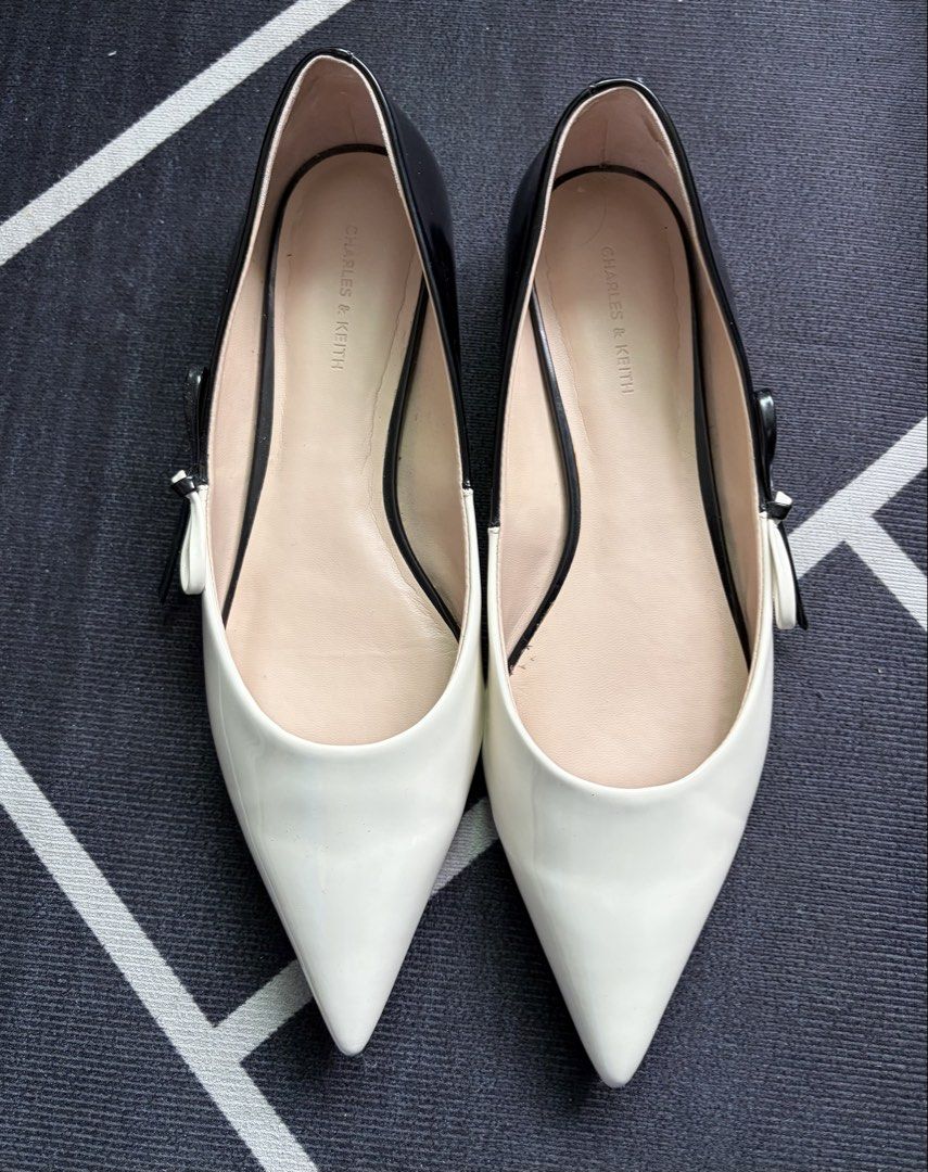Charles & Keith Black and White Pointed Toe Flats (Category: Flats & Sandals) located in Manila. Submitted by puffofclouds (Listing ID 1459747070, Image 2). Description: - Brand: Charles & Keith - Style: Pointed toe flats - Design: Black and white color block - Detail: Small ribbon on the side - Comfort: Ideal for everyday wear - Condition: Please check photos for details Note: It only has some sticky residue left on the inside, but it can be eas