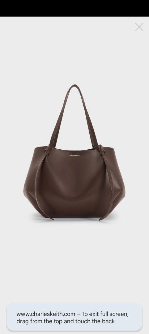 Charles & Keith Brown Tote Bag with Pouch (Category: Tote Bags) located in Caloocan City. Submitted by nobleflower_4c42cc (Listing ID 1459785621, Image 1). Description: - Brand: Charles & Keith - Color: espresso Brown - Style: Slouchy, relaxed tote bag - Features: Comes with a matching inner pouch - Straps: Long, comfortable for shoulder wear - Ideal for: Everyday use, carrying essentials one time used only almost brand-new bought in Singapore.