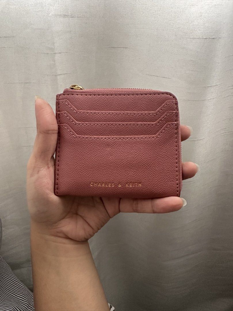 Charles & Keith Pink Card Holder with Zipper (Category: Wallets & Card holders) located in Quezon City. Submitted by ariee_01 (Listing ID 1459770962, Image 1). Description: - Cute pink card holder from Charles & Keith. - Features multiple card slots on the front. - Secure zipper closure for your essentials. - Small and compact design, fits easily in pockets or small bags. - Ideal for everyday use..