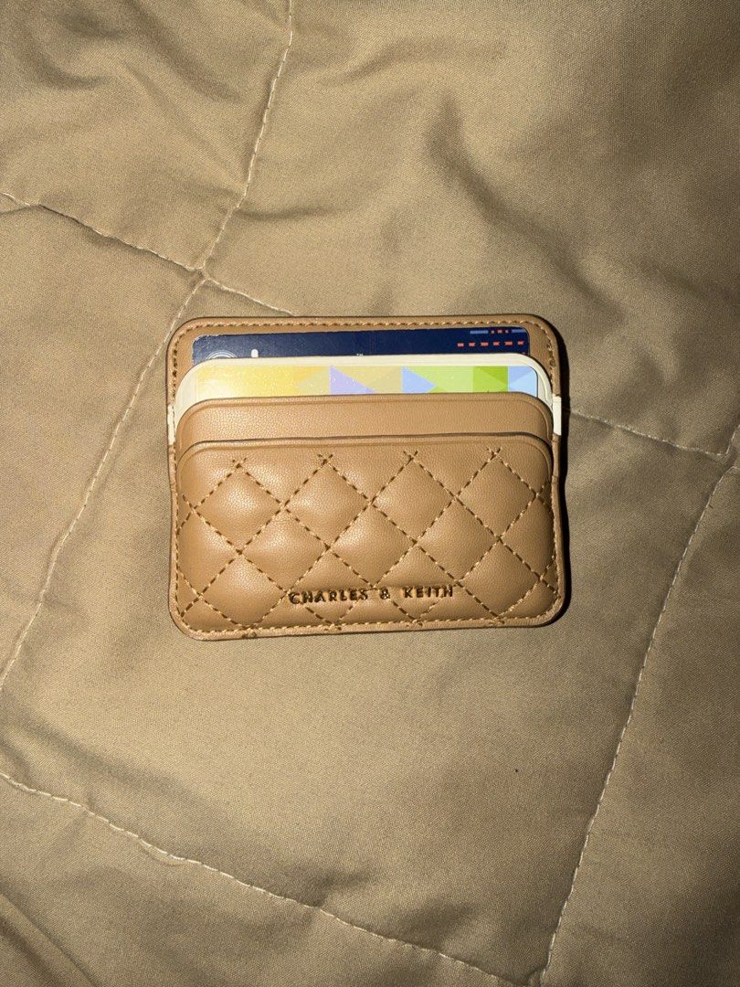 Charles & Keith Quilted Card Holder Tan (Category: Wallets & Card holders) located in Valenzuela. Submitted by royalstone_05 (Listing ID 1459754264, Image 1). Description: - Charles & Keith Tan Quilted Card Holder - Compact and fits multiple cards - Perfect for everyday use - Fits easily in pockets or small bags - Shows some signs of wear on the edges.