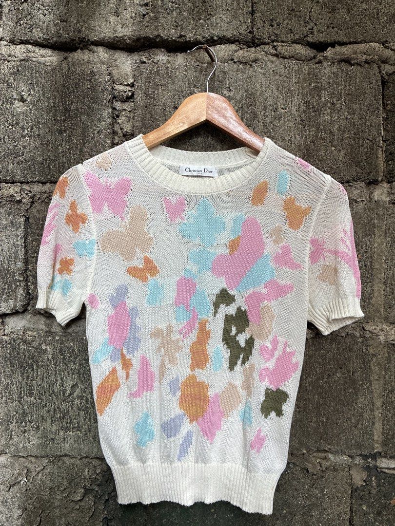 Christian Dior Paris Knit Top (Category: Luxury Apparel) located in Manila. Submitted by assortedgoodsv3 (Listing ID 1459720893, Image 1). Description: - Christian Dior Paris white knit top - Features a vibrant abstract floral pattern - Short sleeves with ribbed hem and neckline - Made in Italy - Size 40 (FR).