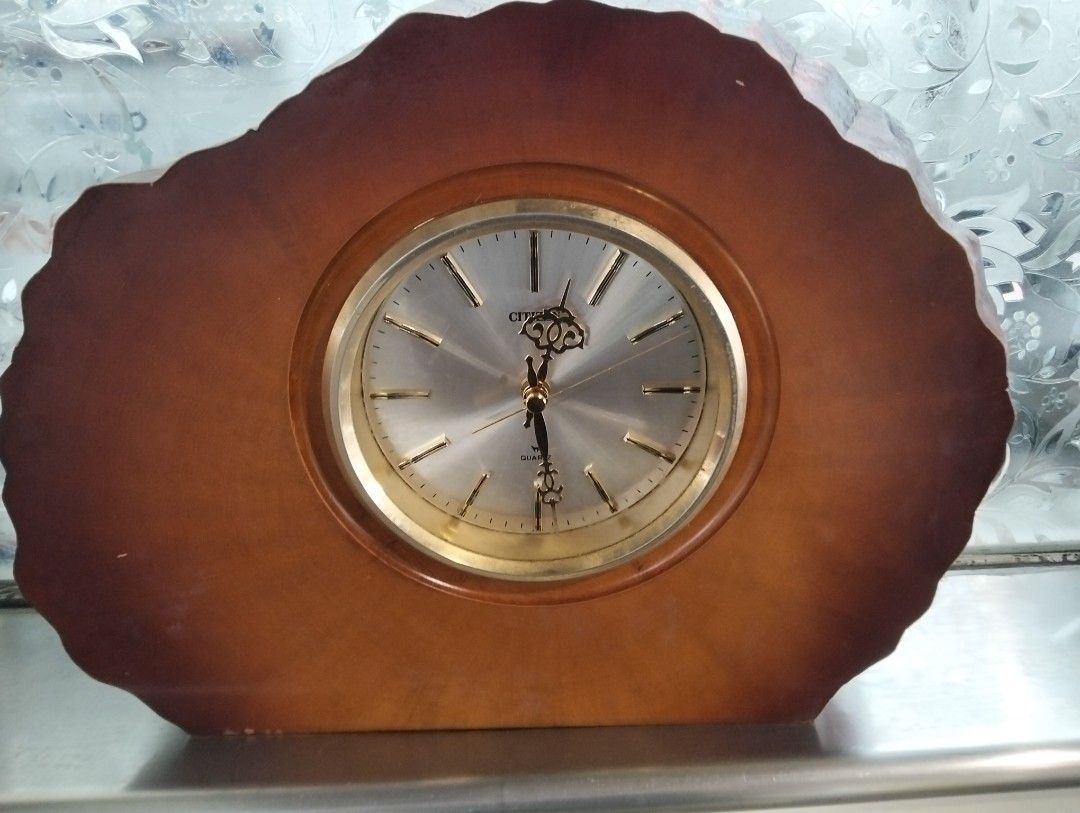 Citizen Quartz Wooden Mantel Clock (Category: Clocks) located in Manila. Submitted by raymundm36884 (Listing ID 1459720052, Image 1). Description: - Elegant wooden mantel clock - Reliable Citizen quartz movement - Unique natural, rough-hewn wood edge casing - Silver clock face with classic gold-tone hour markers and hands - Timeless design, ideal for desks and shelves.
