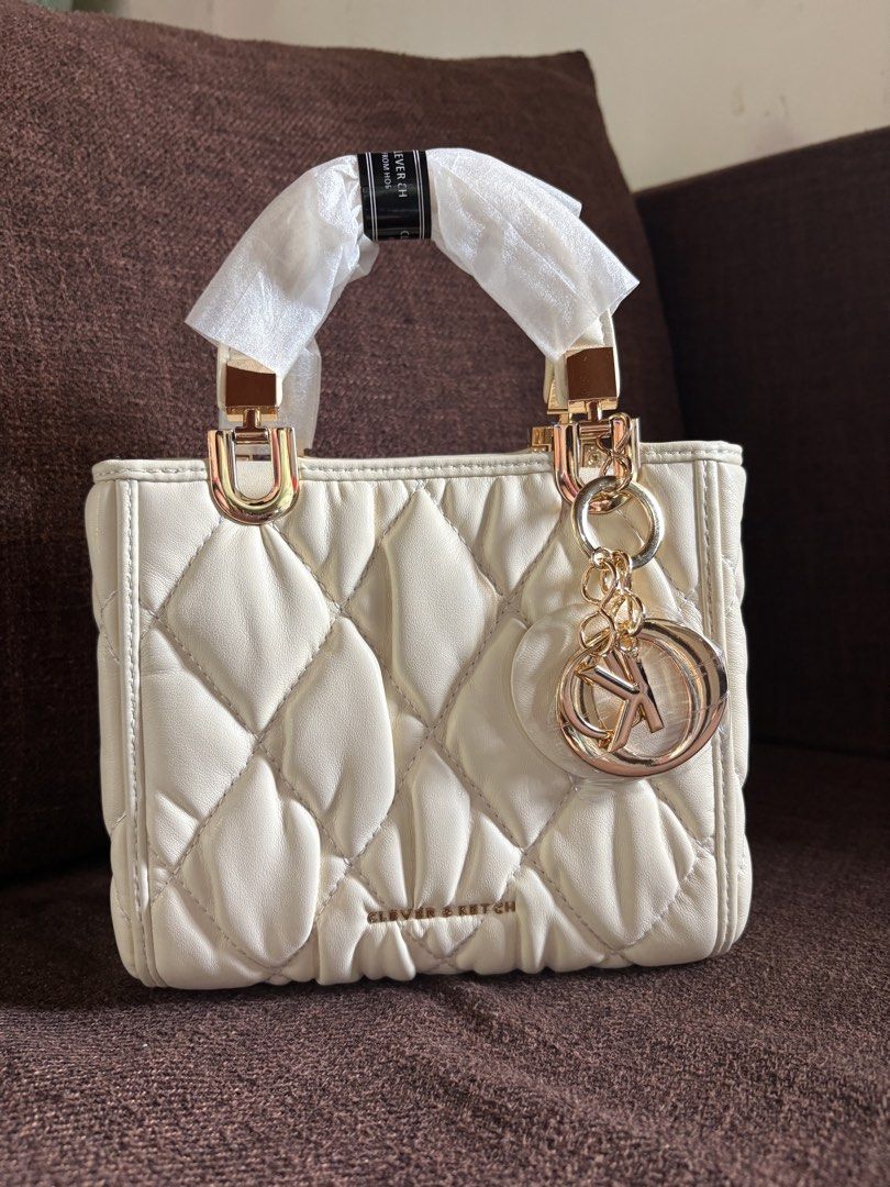 Clever&ketch (Category: Cross-body Bags) located in Pototan. Submitted by tres_190725 (Listing ID 1459764363, Image 3). Description: The selected region shows a cream-colored, diamond-quilted top-handle handbag from the budget-friendly Asian market brand Clever & Ketch, accented with gold-tone hardware and a matching charm. With long strap.