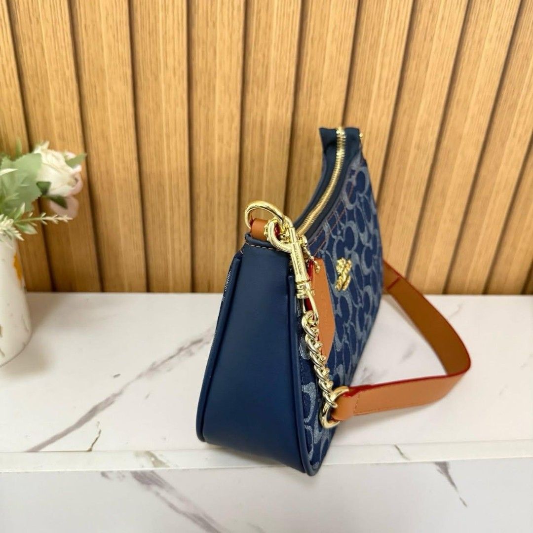 COACH DENIM (Category: Luxury Bags & Wallets) located in Manila. Submitted by luxujeaem (Listing ID 1459816428, Image 2). Description: Mga sis! ✨ Check out this super chic COACH DENIM shoulder bag, perfect for your everyday look! The denim material with the classic Coach monogram is just everything! Plus, it has a cute chain strap with leather accents for that extra touch of style. Perfect size for your essentials, whether you're going out for co