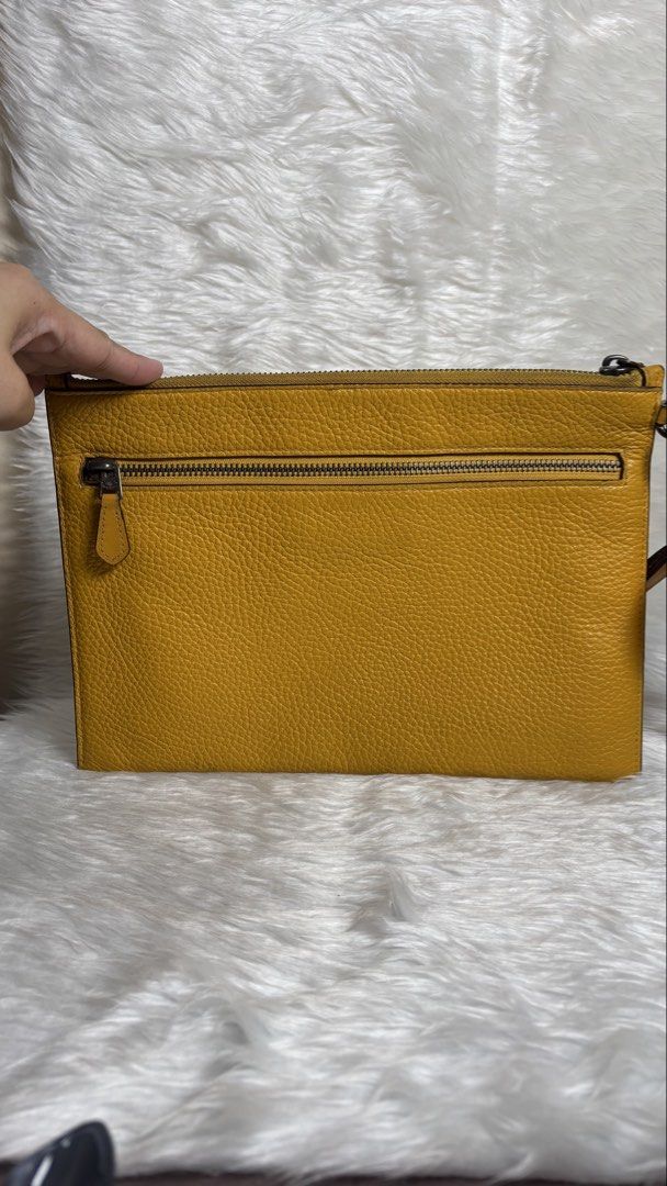 COACH LARGE CORNER ZIP WRISTLET ✨ (Category: Purses & Pouches) located in Manila. Submitted by vintage_og_bagash (Listing ID 1459833648, Image 3). Description: COACH LARGE CORNER ZIP WRISTLET ✨ DETAILS • Brand: Coach • Style: Large Corner Zip Wristlet • Color: Mustard Yellow • Zip-top closure • Spacious interior for cards, cash, phone & small essentials • Wrist strap for easy carry • Comes with a floral charm/accessory as shown 🌸 CONDITION Good 
