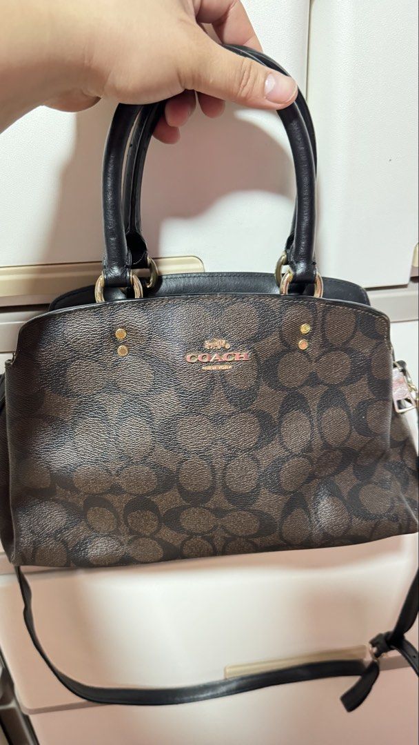 Coach Signature Monogram Satchel Bag (Category: Luxury Bags & Wallets) located in Manila. Submitted by ririkah (Listing ID 1459898578, Image 2). Description: - Classic Coach satchel bag - Brown signature monogram canvas - Black leather trim - Gold hardware details - Top handles - Detachable crossbody strap - Zipper closure - Spacious interior - Great for everyday use.