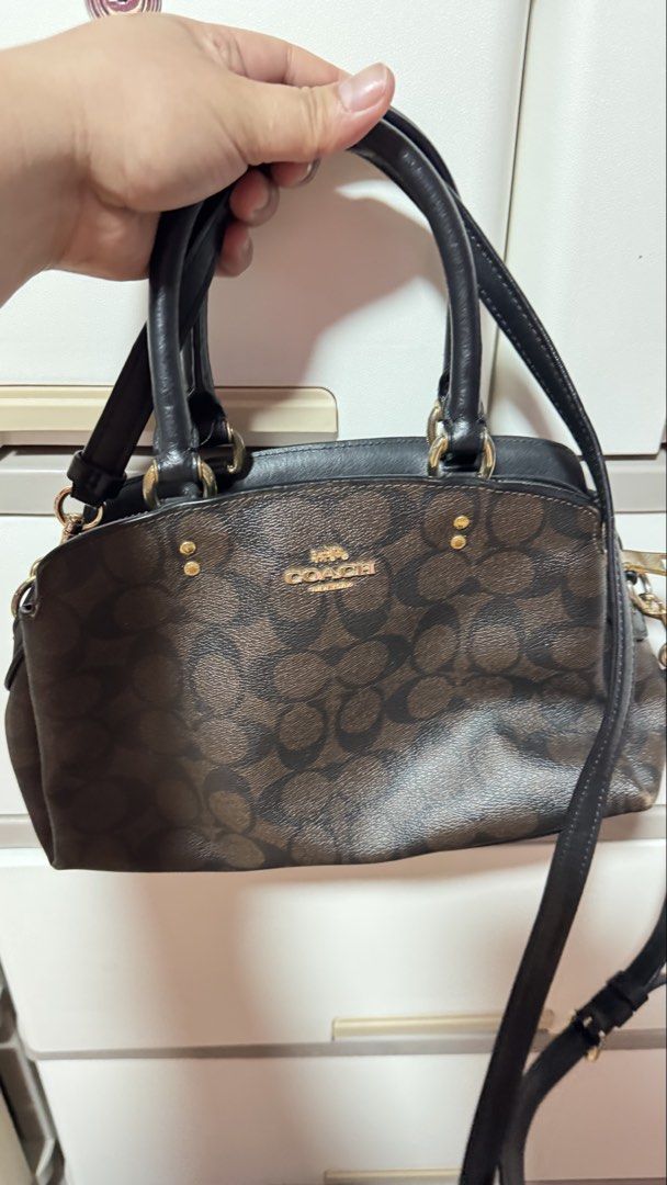 Coach Signature Monogram Satchel Bag (Category: Luxury Bags & Wallets) located in Manila. Submitted by ririkah (Listing ID 1459898578, Image 1). Description: - Classic Coach satchel bag - Brown signature monogram canvas - Black leather trim - Gold hardware details - Top handles - Detachable crossbody strap - Zipper closure - Spacious interior - Great for everyday use.