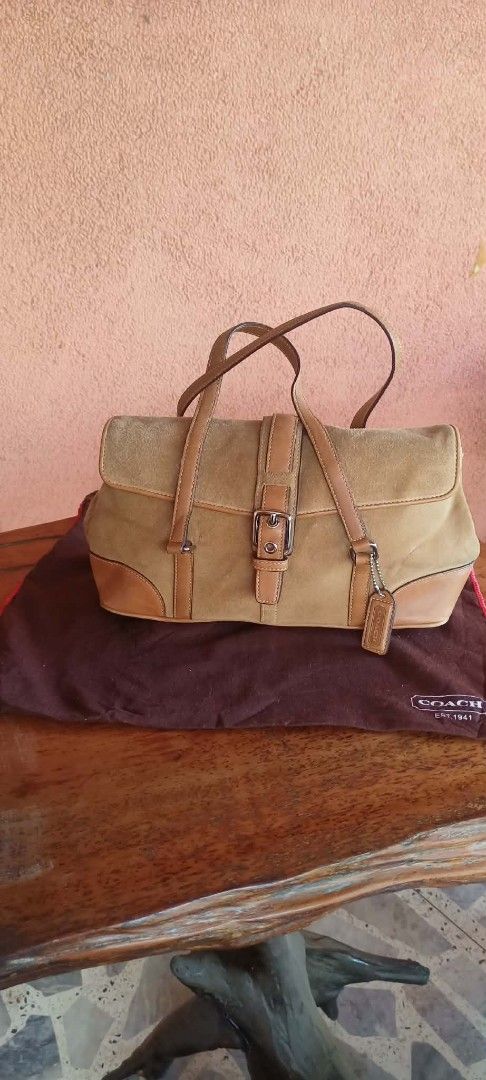 Coach Suede and Leather Shoulder Bag (Category: Luxury Bags & Wallets) located in Tuguegarao City. Submitted by luxthrifttuguegarao (Listing ID 1459716071, Image 2). Description: - Brown suede and tan leather Coach shoulder bag - Secure buckle closure on flap - Adorable cherry charm included - Original dust bag provided - Excellent pre-loved condition.