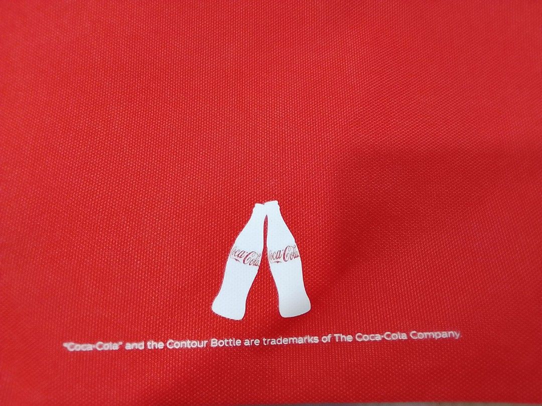 Coca-Cola Red Canvas Sling Pouch Bag (Category: Purses & Pouches) located in Manila. Submitted by newage.vintage (Listing ID 1459804748, Image 3). Description: - Red Coca-Cola pouch bag - Adjustable red rope strap - Zipper closure - Ideal for carrying essentials - Iconic Coca-Cola logo on the front - Simple back design with two white contour bottles - Great for casual outings.