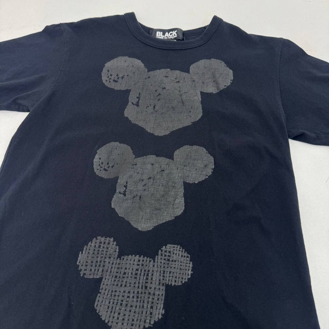 Comme Des Garcon Black X Mickey Mouse print tee (Category: Luxury Apparel) located in Quezon City. Submitted by johnpaulperezzz (Listing ID 1459813938, Image 3). Description: NAME: Comme Des Garcon Black X Mickey Mouse print tee COLOR: Black SIZE: Small FIT: XS Dimension: Width: 17 Length: 24 Shoulder: 16 Sleeves: 7 Hem: 17 CONDITION: 8/10 ISSUE: -hairline crack print at the front print PRICE: 1k .