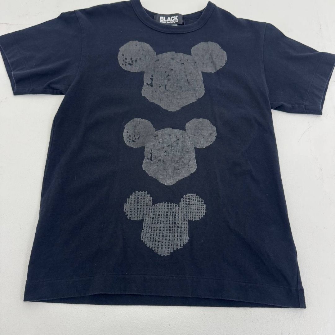 Comme Des Garcon Black X Mickey Mouse print tee (Category: Luxury Apparel) located in Quezon City. Submitted by johnpaulperezzz (Listing ID 1459813938, Image 2). Description: NAME: Comme Des Garcon Black X Mickey Mouse print tee COLOR: Black SIZE: Small FIT: XS Dimension: Width: 17 Length: 24 Shoulder: 16 Sleeves: 7 Hem: 17 CONDITION: 8/10 ISSUE: -hairline crack print at the front print PRICE: 1k .