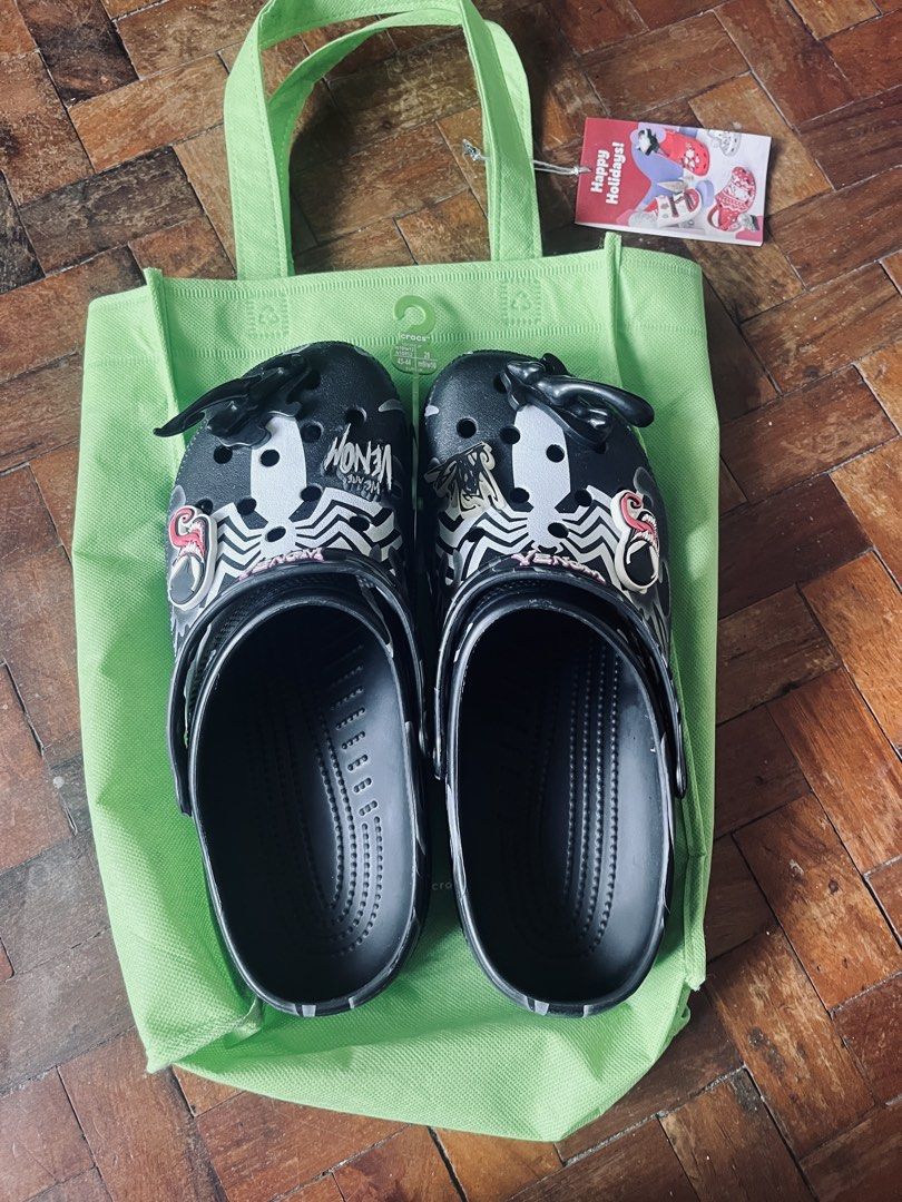 Crocs Venom Clogs with Bag (Category: Slippers & Slides) located in Cavite. Submitted by _aele3 (Listing ID 1459767536, Image 2). Description: - Cool Venom Crocs clogs - Black with white Venom graphics and spider webs - Comes with a green Crocs reusable bag - Size: 43-44 Adult - Perfect for Marvel fans 2nd Hand. Good as new Last price po tayo. Thank you & God Bless.