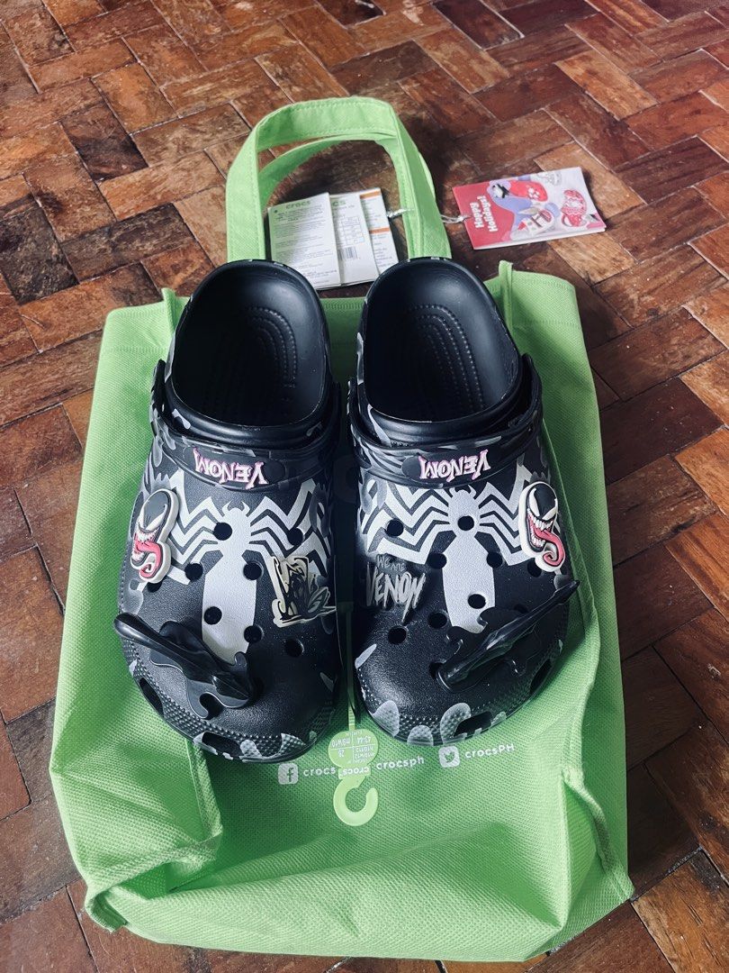 Crocs Venom Clogs with Bag (Category: Slippers & Slides) located in Cavite. Submitted by _aele3 (Listing ID 1459767536, Image 1). Description: - Cool Venom Crocs clogs - Black with white Venom graphics and spider webs - Comes with a green Crocs reusable bag - Size: 43-44 Adult - Perfect for Marvel fans 2nd Hand. Good as new Last price po tayo. Thank you & God Bless.