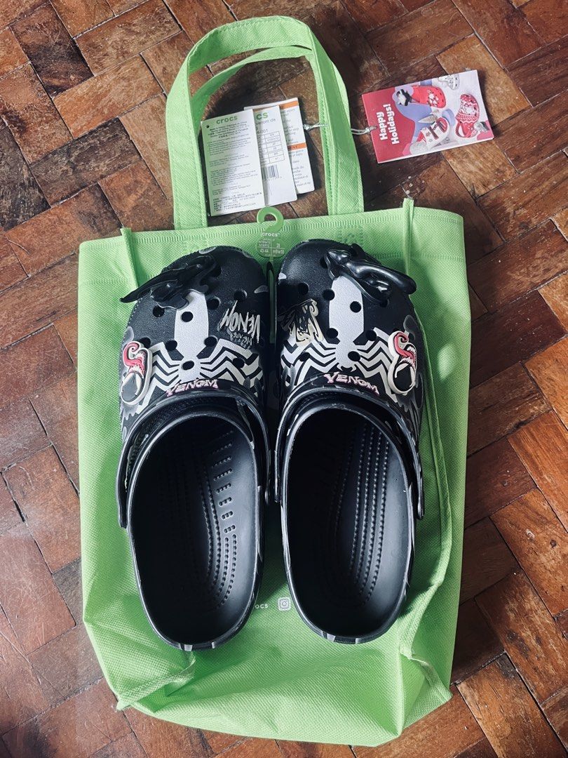 Crocs Venom Clogs with Bag (Category: Slippers & Slides) located in Cavite. Submitted by _aele3 (Listing ID 1459767536, Image 3). Description: - Cool Venom Crocs clogs - Black with white Venom graphics and spider webs - Comes with a green Crocs reusable bag - Size: 43-44 Adult - Perfect for Marvel fans 2nd Hand. Good as new Last price po tayo. Thank you & God Bless.