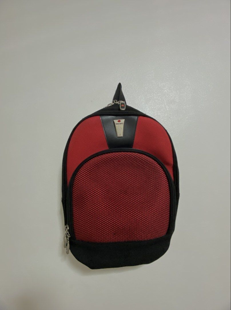 Delsey red and black small backpack with mesh front pocket (Category: Luxury Bags & Wallets) located in Manila. Submitted by prelovedbymacybm (Listing ID 1459826501, Image 1). Description: Brand: Delsey Color: Red and black Material: polyester/nylon with mesh pocket RFS: Decluttering Issue: minor scratches Mode of Payment: Gcash/Maribank.