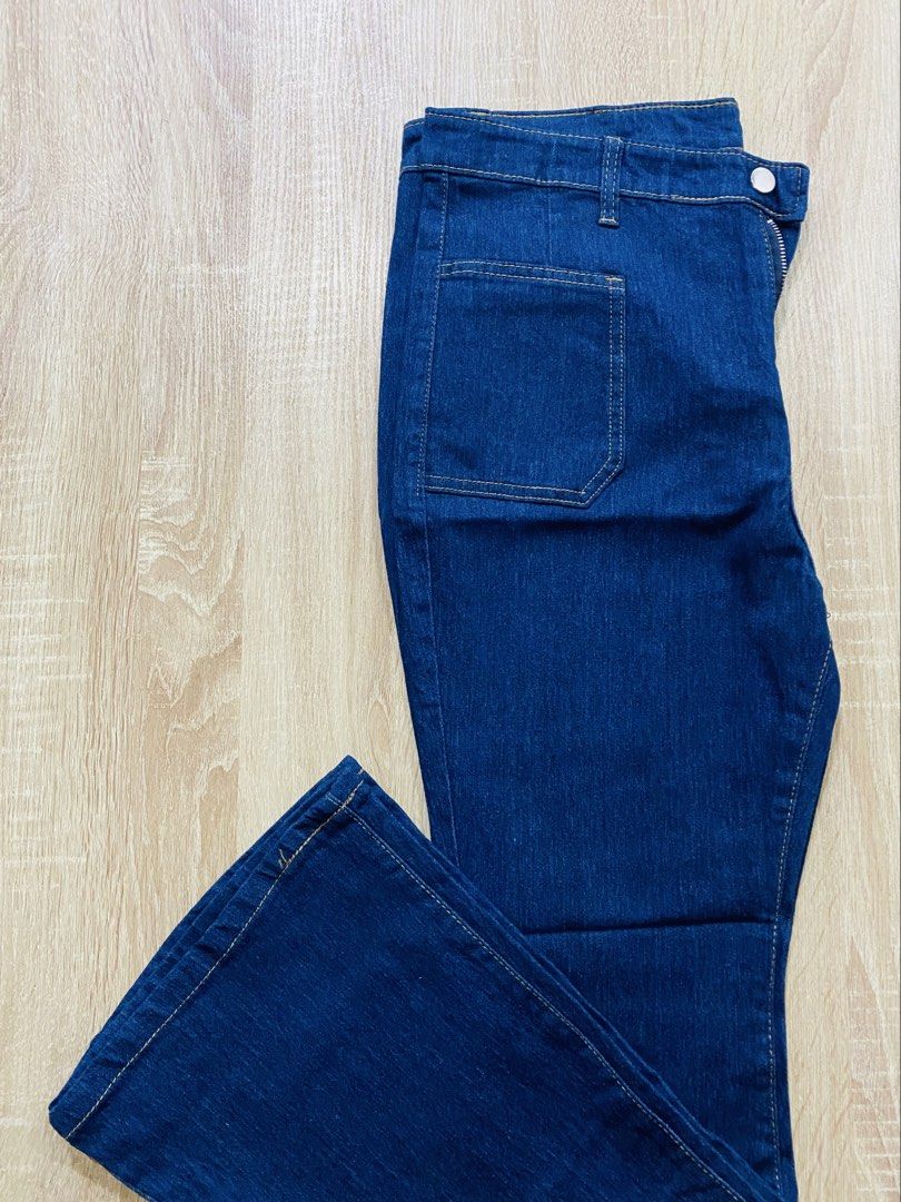 Denim blue Flare Jeans (Category: Jeans) located in Indang. Submitted by matilde.sshop (Listing ID 1459877252, Image 1). Description: - Dark wash denim jeans - Trendy flare leg style - Front zipper and button closure - Two front pockets with stitching detail - Classic five-pocket design - Ideal for everyday casual wear.