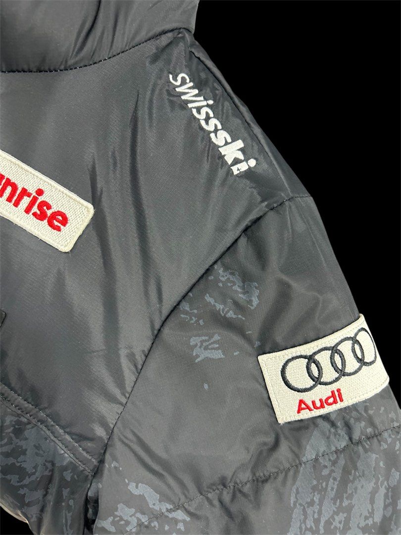 Descente x Audi Swiss Ski Team Puffer Jacket (Category: Coats, Jackets and Outerwear) located in Manila. Submitted by bodegabodega (Listing ID 1459772110, Image 3). Description: - Authentic Descente puffer jacket - Official Swiss Ski Team gear - Multiple sponsor patches: Raiffeisen, Helvetia, BKW, Sunrise, Audi - Features Audi rings and Swiss Ski logos - Subtle patterned exterior - Black inner lining with patterned panel - Descente branded zipper
