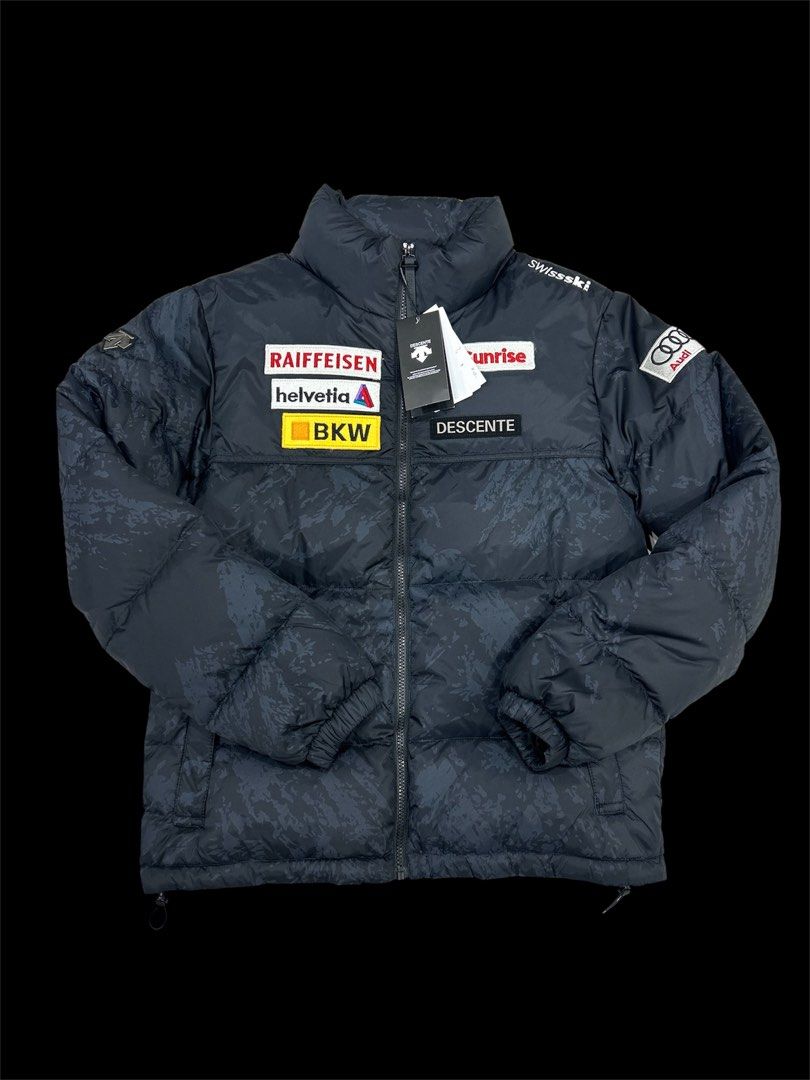 Descente x Audi Swiss Ski Team Puffer Jacket (Category: Coats, Jackets and Outerwear) located in Manila. Submitted by bodegabodega (Listing ID 1459772110, Image 1). Description: - Authentic Descente puffer jacket - Official Swiss Ski Team gear - Multiple sponsor patches: Raiffeisen, Helvetia, BKW, Sunrise, Audi - Features Audi rings and Swiss Ski logos - Subtle patterned exterior - Black inner lining with patterned panel - Descente branded zipper