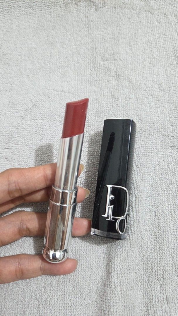 Dior Iconic Lipstick - Shade 720 (Icone) (Category: Makeup) located in Taguig. Submitted by tipidd (Listing ID 1459737554, Image 3). Description: - Authentic Dior Iconic Lipstick - Shade: 720 (Icone) - Features: Iconic black case with silver 'CD' logo - Texture: Smooth application - Versatile: Ideal for everyday wear or evening events - Condition: Comes with original case.