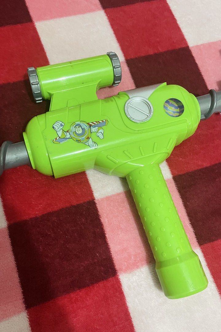 Disney Parks Buzz Lightyear Star Command Claw Grabber toy (Category: Action & Battle Toys) located in Quezon City. Submitted by sissymissy1527 (Listing ID 1459807566, Image 3). Description: Design: Molded green and purple plastic body with a silver-colored coiled spring neck. Function: Features a mechanical gray grabbing claw on one end and a spinning or gripping handle feature. Theme: Inspired by the Toy Story franchise and Star Command branding