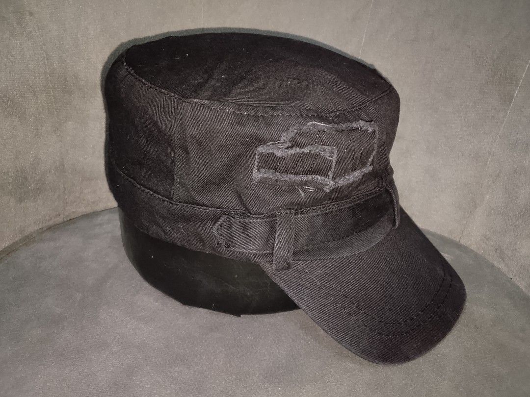 Distressed Design Military Style Cadet Cap (Category: Caps & Hats) located in Binangonan. Submitted by yuristalin888 (Listing ID 1459813242, Image 3). Description: This black cadet/military-style cap is made from a durable twill fabric and features a structured flat-top crown and a curved brim. It is styled with a wraparound band detail and distinct distressed, frayed patch accents on the sides..