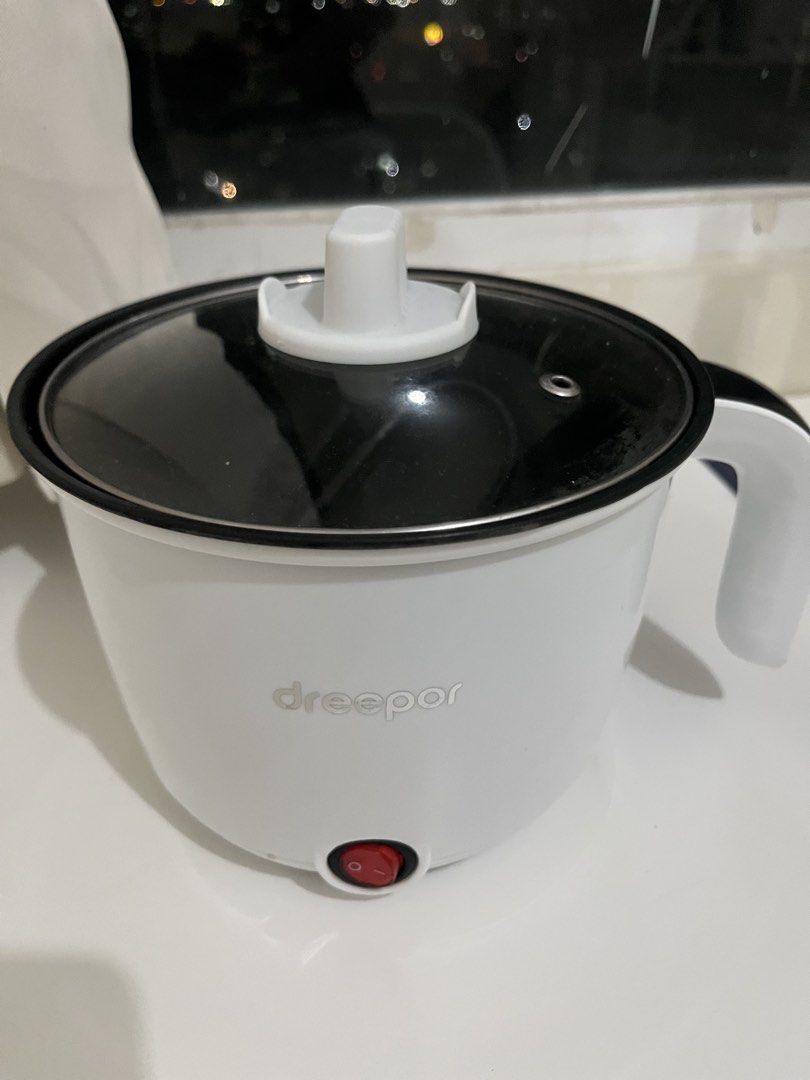 Dreepor Electric Pot with Glass Lid (Category: Cookware & Accessories) located in Manila. Submitted by gentlefish_473ecf (Listing ID 1459845792, Image 2). Description: - White Dreepor electric pot - Includes glass lid and power cord - Black inner pot - Perfect for cooking small meals or boiling water - Simple red switch for easy operation - Compact size, great for dorm rooms or small kitchens slight issue: check pics inside pot and electric wire,