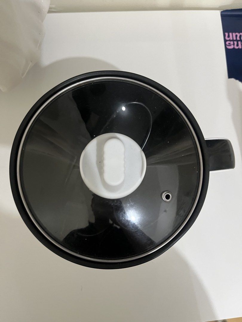 Dreepor Electric Pot with Glass Lid (Category: Cookware & Accessories) located in Manila. Submitted by gentlefish_473ecf (Listing ID 1459845792, Image 1). Description: - White Dreepor electric pot - Includes glass lid and power cord - Black inner pot - Perfect for cooking small meals or boiling water - Simple red switch for easy operation - Compact size, great for dorm rooms or small kitchens slight issue: check pics inside pot and electric wire,
