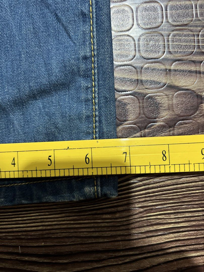 DSQUARED2 Distressed Blue Denim Jeans (Category: Jeans) located in Manila. Submitted by okeanos (Listing ID 1459756206, Image 2). Description: - Trendy blue denim jeans - Distressed details and rips for an edgy look - Classic five-pocket styling - Secure button and zip closure - Eye-catching yellow stitching throughout - Approx. 15 inches across the waist - Approx. 6.5 inches across the leg opening - Ideal for creating a stylish casual outfit.