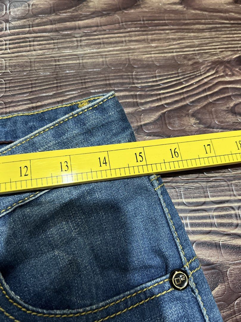 DSQUARED2 Distressed Blue Denim Jeans (Category: Jeans) located in Manila. Submitted by okeanos (Listing ID 1459756206, Image 3). Description: - Trendy blue denim jeans - Distressed details and rips for an edgy look - Classic five-pocket styling - Secure button and zip closure - Eye-catching yellow stitching throughout - Approx. 15 inches across the waist - Approx. 6.5 inches across the leg opening - Ideal for creating a stylish casual outfit.