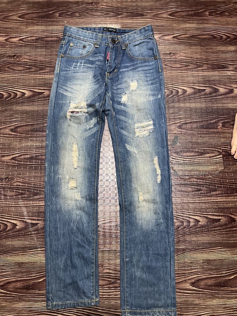 DSQUARED2 Distressed Blue Denim Jeans (Category: Jeans) located in Manila. Submitted by okeanos (Listing ID 1459756206, Image 1). Description: - Trendy blue denim jeans - Distressed details and rips for an edgy look - Classic five-pocket styling - Secure button and zip closure - Eye-catching yellow stitching throughout - Approx. 15 inches across the waist - Approx. 6.5 inches across the leg opening - Ideal for creating a stylish casual outfit.