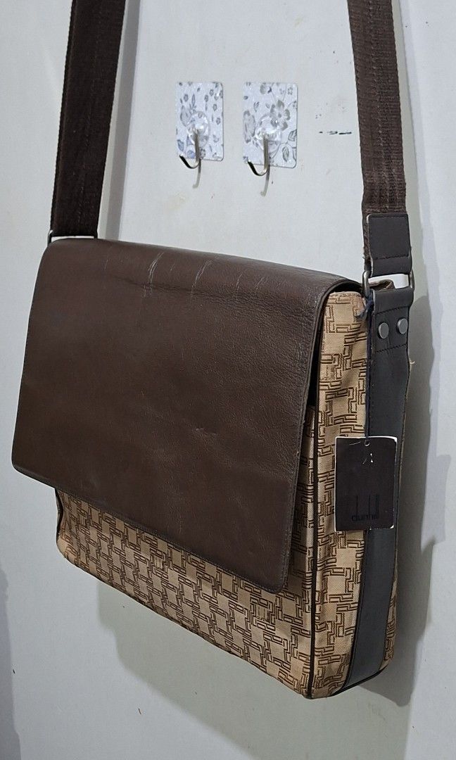 Dunhill Monogram Leather Messenger Bag (Category: Luxury Bags & Wallets) located in Quezon City. Submitted by moonthrifting (Listing ID 1459819614, Image 1). Description: - Authentic Dunhill monogram messenger bag - Color: Brown - Materials: Leather and canvas - Origin: Made in France - Features: Zippered main compartment, internal pockets - Strap: Adjustable for comfort - Style: Classic and stylish for daily use.