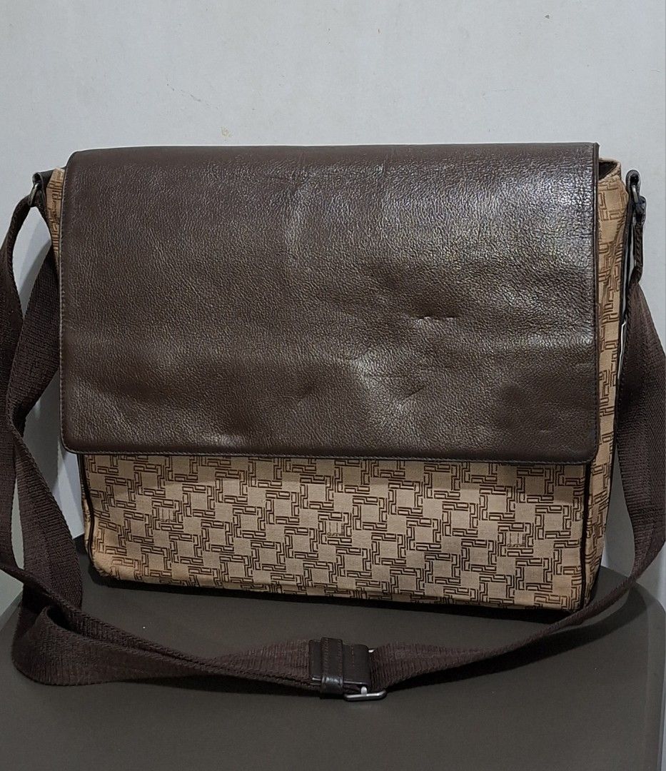 Dunhill Monogram Leather Messenger Bag (Category: Luxury Bags & Wallets) located in Quezon City. Submitted by moonthrifting (Listing ID 1459819614, Image 2). Description: - Authentic Dunhill monogram messenger bag - Color: Brown - Materials: Leather and canvas - Origin: Made in France - Features: Zippered main compartment, internal pockets - Strap: Adjustable for comfort - Style: Classic and stylish for daily use.