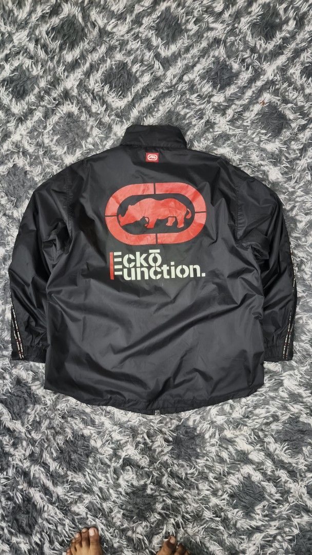 Ecko Function Light Zipper Jacket (Category: Coats, Jackets and Outerwear) located in Klang. Submitted by trussarce.my (Listing ID 1459851089, Image 1). Description: Size XL Arm Pit 25 Length 31 - Black Ecko Function jacket - Iconic rhino logo on the back - Zip-up front with pockets - Striped detailing on sleeves and collar - Ideal for casual wear.